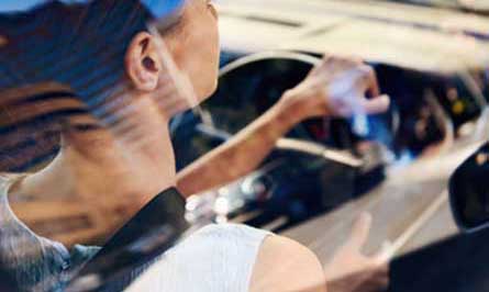 Woman holding steering wheel in car